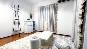 a white room with a toilet and a refrigerator at Tokyo Hoshino House 1Floor in Tokyo