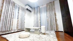 a living room with a table and a white rug at Tokyo Hoshino House 1Floor in Tokyo +74 photos