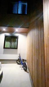 a motorcycle parked in a room with a wall at Tokyo Hoshino House 1Floor in Tokyo