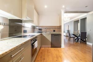 a large kitchen with a counter and a dining room at Cape Royale Elegance & Comfort in Cape Town