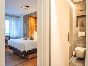 a bedroom with a bed and a bathroom at Apartment Chesa Fleury by Interhome in St. Moritz