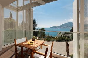 a dining room with a view of the ocean at Dukley Hotel & Resort in Budva