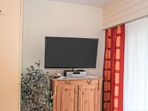 a flat screen tv sitting on top of a wooden cabinet at Apartment Am Birkenhain-28 by Interhome in Seefeld in Tirol