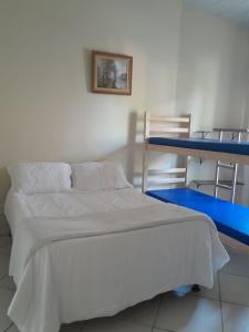 a bedroom with a bed and a bunk bed at Hostel Peró Cabo Frio in Cabo Frio +19 photos