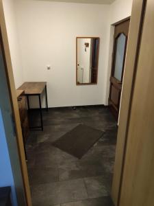 an empty room with a mirror and a table at Ferienwohnung am Rennsteig in Gerstungen
