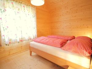 a bedroom with two beds in a wooden room at Chalet Chalet Stressless I by Interhome in Presseggen