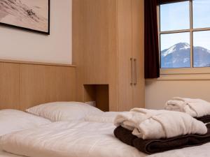a bedroom with two beds with towels on them at Apartment Mountain Resort C15 by Interhome in Kaprun