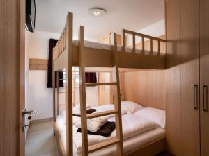 a bunk bed room with two bunk beds at Apartment Mountain Resort C15 by Interhome in Kaprun