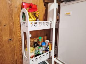 a door of a refrigerator with food inside at Apartment Vreneli by Interhome in Lauterbrunnen