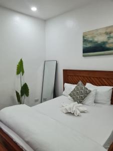 een slaapkamer met een bed met witte handdoeken bij Didas Villa Stay Deluxe in Arusha