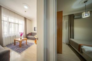 a room with a bed and a table in a room at Feyza Apart in Istanbul