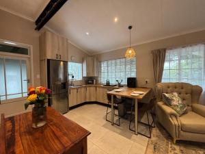 a large kitchen with a table and a couch and a table at La Casa Blanca in Johannesburg
