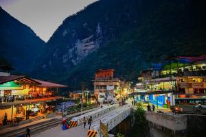 a city with a train station and a mountain at Hospedaje San Francisco in Machu Picchu