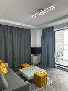 a living room with a couch and a table at Lake On Exclusive in Mamaia