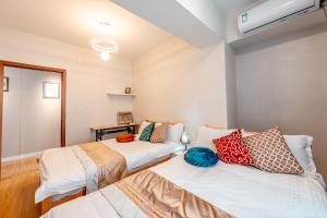 two beds in a room with avertisement for at Ulaanbaatar Sky Residence in Ulaanbaatar