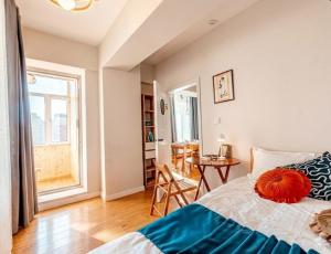a bedroom with a bed and a table and a window at Ulaanbaatar Sky Residence in Ulaanbaatar +42 photos