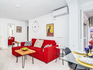 ein Wohnzimmer mit einem roten Sofa und einem Tisch in der Unterkunft Apartment Diana by Interhome in Benalmadena Costa