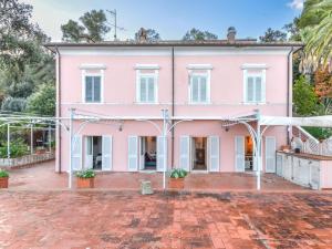 a pink house with a brick driveway at Apartment Villa Le Palme by Interhome in Rio Marina +55 photos