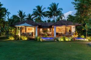 a house with a garden at night at Tua Pousada Boutique Tatuamunha, Rota Ecológica dos Milagres, Porto de Pedras, Alagoas in Tatuamunha