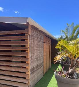 a building with a fence and some plants at Chez Permal in Saint-Pierre