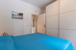 En eller flere senge i et værelse på Casa Acquamarina by ElbaSummer