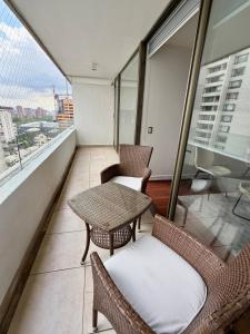 een balkon met een tafel en stoelen op een gebouw bij Sky Park Elite in Santiago