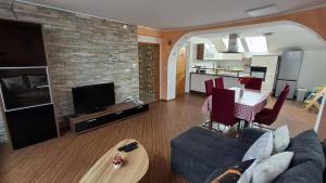 a living room with a couch and a dining room at Hiša Bizjak in Kranj