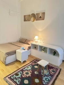 a bedroom with a bed and a desk and a rug at HuếDuo Homestay in Thôn Trường Giang