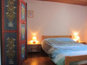 una camera da letto con un letto e due lampade su due tavoli di les Beraudes 1 a Névache
