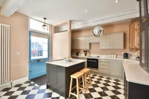 a kitchen with a black and white checkered floor at 1 Purfleet Quay in King's Lynn