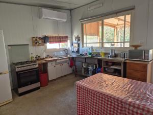 a kitchen with a stove and a counter top at חאן בכפר במשק בלה מאיה - האוהל in Nevatim