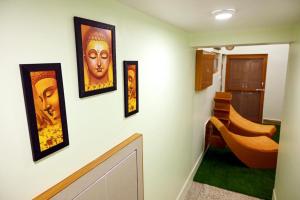 a hallway with four pictures on a wall at Madhi Basera in Varanasi
