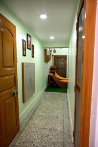 a hallway with a room with a bed and a door at Madhi Basera in Varanasi +12 photos