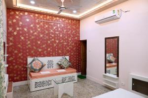 a living room with a red wall at Madhi Basera in Varanasi