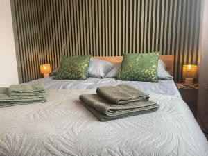 a bed with towels sitting on top of it at Apartament -Jak w domu- Czeladź 60m2 Centrum Katowic 10km in Czeladź