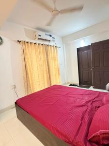 a bedroom with a large bed with a red blanket at Square Greens in Siolim +8 photos