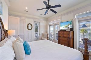 a bedroom with a bed and a ceiling fan at Arrabella - Gulf Views with Deck & Community Pool in Santa Rosa Beach +43 photos