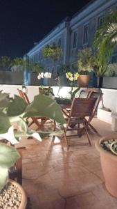 a patio with chairs and a table on a balcony at Pompei suite via roma 16 in Pompei