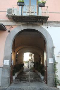 an archway with a balcony on top of a building at Pompei suite via roma 16 in Pompei