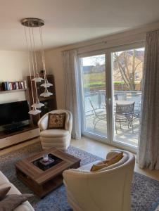 a living room with a large sliding glass door at "Villa Harmonie" direkt am Golfplatz in Göhren-Lebbin