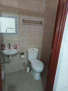 a bathroom with a toilet and a sink at Studio BNB Meru town CBD in Meru +16 photos