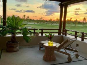 a resort balcony with a chair and a golf course at Lagos Del Mar - Casa Dos Vistas in Punta Mita