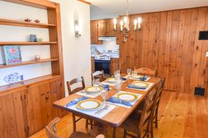 a wooden dining room with a table and chairs at Walk to Water w Stunning Cove Views in Eastham +29 photos