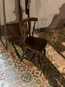 una sedia di legno appoggiata su un pavimento piastrellato di Casa Doramas a San José de Caideros