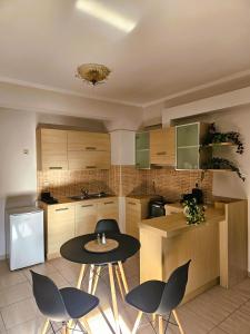 a kitchen with a table and chairs in a kitchen at Despina's house in Ioannina