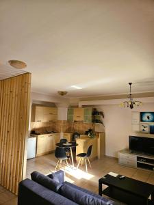 a living room with a couch and a table and a kitchen at Despina's house in Ioannina