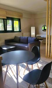 a living room with a couch and a table and chairs at Despina's house in Ioannina