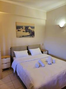 a hotel room with two beds with towels on them at Despina's house in Ioannina +5 photos