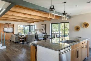 a kitchen and living room with wooden ceilings at Stay at Old Garden Beach in Rockport