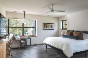 a bedroom with a bed and a couch and windows at Stay at Old Garden Beach in Rockport